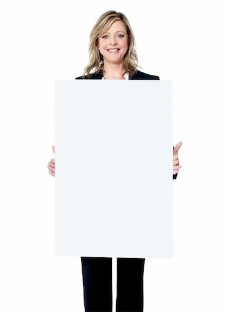 simsearch:400-06695536,k - Young beautiful woman standing behind blank white billboard Stock Photo - Budget Royalty-Free & Subscription, Code: 400-06482633