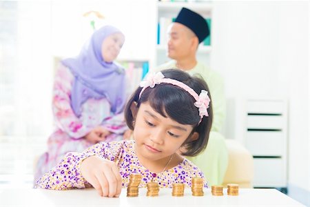 Southeast Asian girl money savings concept. Asian family living lifestyle. Foto de stock - Super Valor sin royalties y Suscripción, Código: 400-06483267