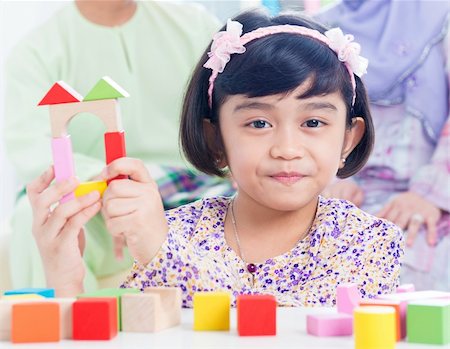 father daughter blocks - Muslim child building wooden house. Southeast Asian girl playing woodblock house at home. Stock Photo - Budget Royalty-Free & Subscription, Code: 400-06483274