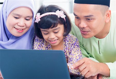 Southeast Asian family browsing internet at home. Muslim family living lifestyle Stock Photo - Budget Royalty-Free & Subscription, Code: 400-06483287