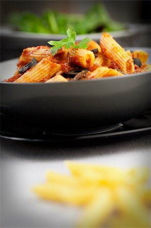 Italian food. Pasta penne with tomato sauce, olives and garnish Stock Photo - Budget Royalty-Free & Subscription, Code: 400-06517331