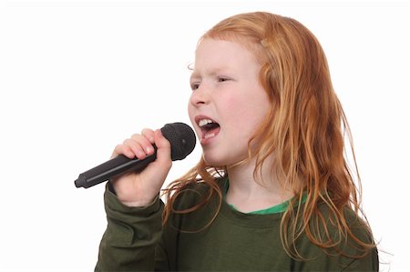 Young red haired girl singing into microphone on white background Stock Photo - Budget Royalty-Free & Subscription, Code: 400-06517476