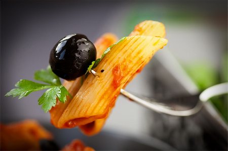 Italian food. Pasta penne with tomato sauce, olives and garnish Stock Photo - Budget Royalty-Free & Subscription, Code: 400-06517578