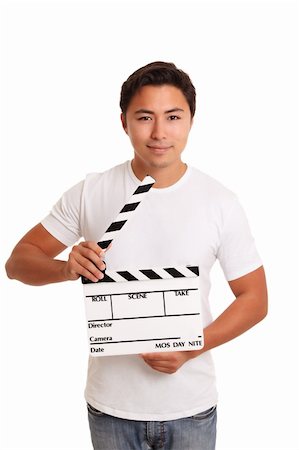 Man holding a film slate wearing a white t-shirt. White background. Photographie de stock - Aubaine LD & Abonnement, Code: 400-06519417
