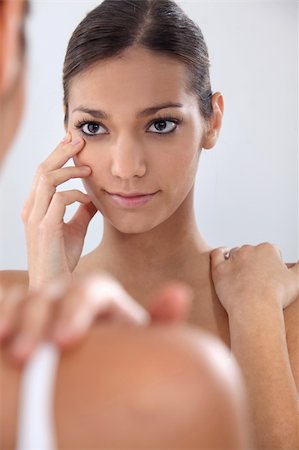 Woman putting in her contact lenses Stock Photo - Budget Royalty-Free & Subscription, Code: 400-06519544