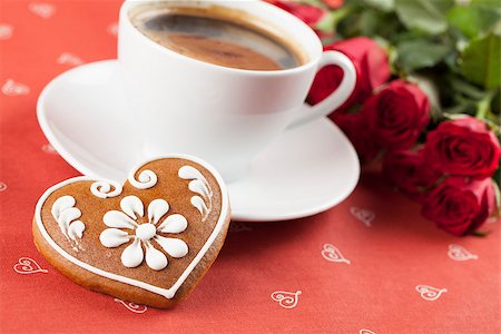 Gingerbread heart with coffee and red roses on red background. Shallow dof Stock Photo - Budget Royalty-Free & Subscription, Code: 400-06524203