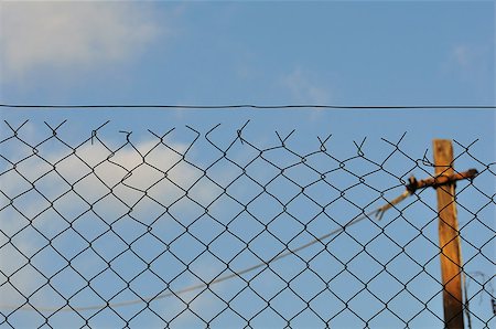 simsearch:400-05300192,k - Chain link fence and blue sky urban background. Stock Photo - Budget Royalty-Free & Subscription, Code: 400-06524421