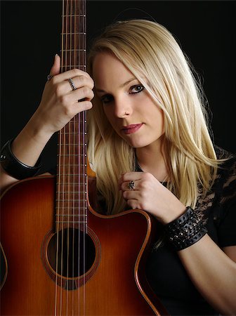 shadow acoustic guitar - Photo of a young blond female holding an acoustic guitar. Stock Photo - Budget Royalty-Free & Subscription, Code: 400-06524441