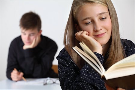 students reading book in classroom teen - Photo of a young student reading a book in her classroom. Stock Photo - Budget Royalty-Free & Subscription, Code: 400-06524454