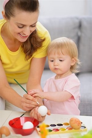 Happy mother and baby painting on Easter eggs Stock Photo - Budget Royalty-Free & Subscription, Code: 400-06525194