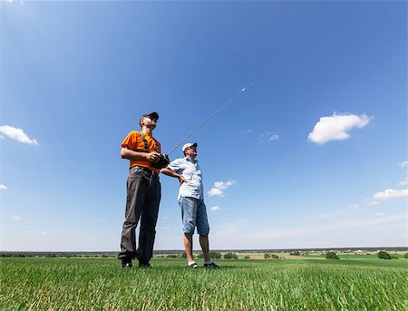 remote control toy - Two Man controls RC gliders in the sky Stock Photo - Budget Royalty-Free & Subscription, Code: 400-06525794