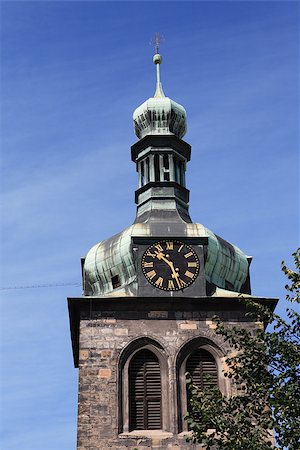 Closeup of old belfry with clock against blue sky Stock Photo - Budget Royalty-Free & Subscription, Code: 400-06526519