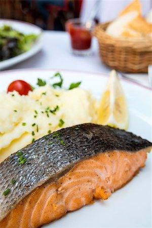 poached salmon - grilled salmon and lemon - french cuisine dish with tomato and salmon Stock Photo - Budget Royalty-Free & Subscription, Code: 400-06526573