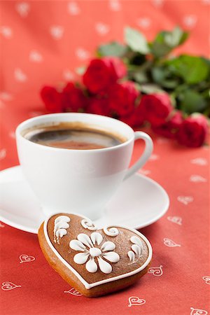 Gingerbread heart with coffee and red roses on red background. Shallow dof Stock Photo - Budget Royalty-Free & Subscription, Code: 400-06526716