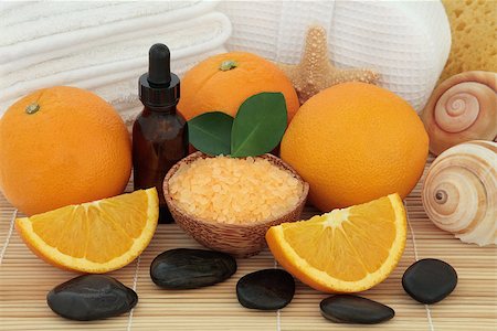 Orange fruit with spa accessories of white towels, stones, sea salt, aromatherapy essential oil bottle, sponge and sea shells over bamboo background. Stock Photo - Budget Royalty-Free & Subscription, Code: 400-06527791