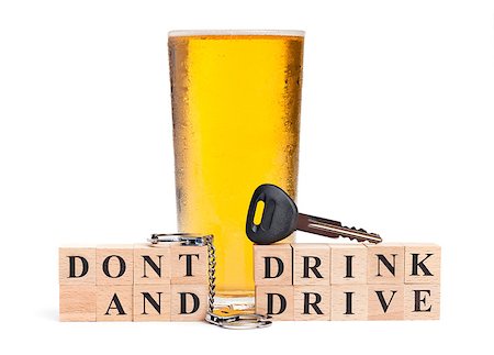 simsearch:400-05195371,k - A pint of beer with a miniature pair of handcuffs and car key atop blocks spelling out Don't Drink and Drive isolated on a white background Photographie de stock - Aubaine LD & Abonnement, Code: 400-06528728