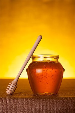 simsearch:400-06640106,k - Honey jar with dipper on table, canvas background Stock Photo - Budget Royalty-Free & Subscription, Code: 400-06529336