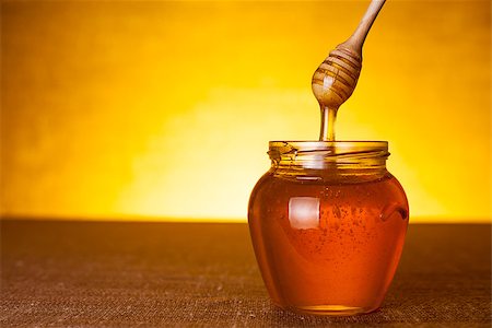 simsearch:400-06640106,k - Honey jar with dipper and flowing honey, canvas background Stock Photo - Budget Royalty-Free & Subscription, Code: 400-06529337