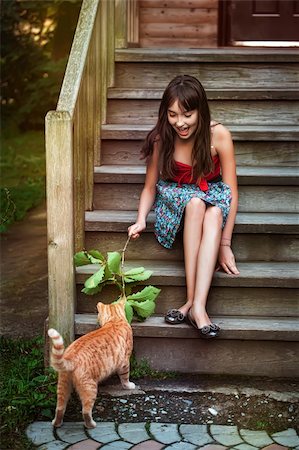 fotolit (artist) - Girl in red dress playing with cat Foto de stock - Royalty-Free Super Valor e Assinatura, Número: 400-06520162
