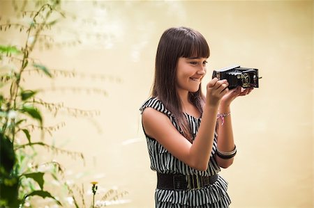fotolit (artist) - Girl with antique camera staying by a lake Foto de stock - Royalty-Free Super Valor e Assinatura, Número: 400-06520163