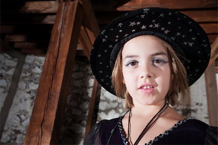 Adorable young female witch wearing cap with stars Stock Photo - Budget Royalty-Free & Subscription, Code: 400-06521114