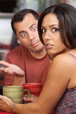 Embarrassed woman arguing a in a restaurant with man Stock Photo - Budget Royalty-Free & Subscription, Code: 400-06521171