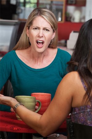 Outraged European woman across from person in a coffeehouse Foto de stock - Super Valor sin royalties y Suscripción, Código: 400-06521191