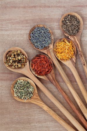 Herb selection for alternative medicinal use use in olive wood spoons over papyrus background. Photographie de stock - Aubaine LD & Abonnement, Code: 400-06521203