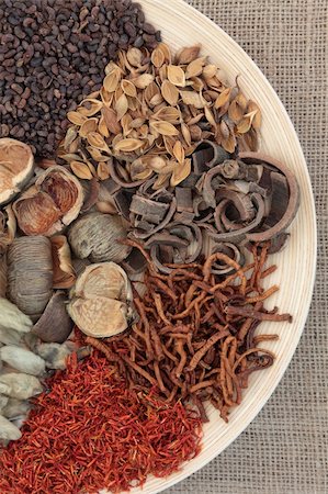 Chinese traditional herbal medicine selection on a round wooden bowl over hessian background. Stock Photo - Budget Royalty-Free & Subscription, Code: 400-06521312
