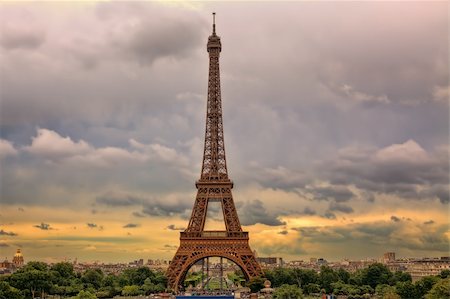 simsearch:400-07111412,k - Famous Eiffel Tower under beautiful cloudy sky at sunset in Paris, France. Photographie de stock - Aubaine LD & Abonnement, Code: 400-06521929