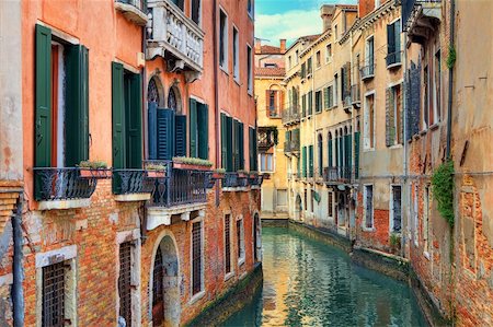 Narrow canal among old colorful brick houses in Venice, Italy. Stock Photo - Budget Royalty-Free & Subscription, Code: 400-06521931