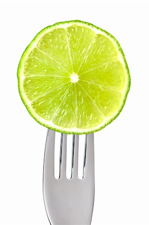 eelnosiva (artist) - fresh lime fruit slice on a fork isolated against white background Foto de stock - Royalty-Free Super Valor e Assinatura, Número: 400-06521941