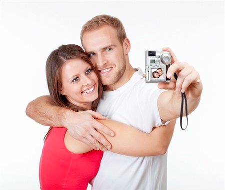 happy young couple taking pictures of themselves - isolated on white Stock Photo - Budget Royalty-Free & Subscription, Code: 400-06522190