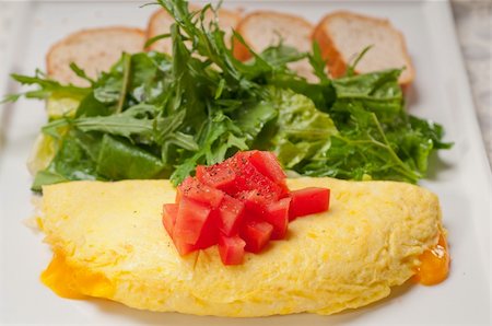 home made omelette with cheese tomato and rucola rocket salad arugola Stock Photo - Budget Royalty-Free & Subscription, Code: 400-06522363