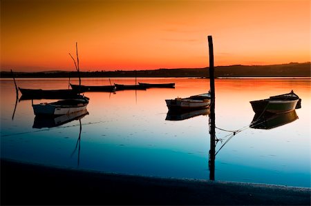 fishing dawn tranquil - Beautiful landscape of a river and boats at sunset Stock Photo - Budget Royalty-Free & Subscription, Code: 400-06522772