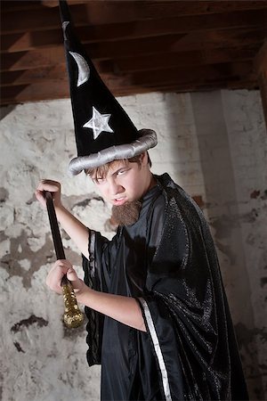 Menacing teenager dressed as wizard with tall hat and scepter Stock Photo - Budget Royalty-Free & Subscription, Code: 400-06522826