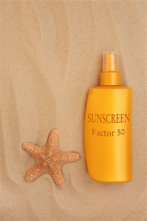 sun care - Factor fifty sunscreen bottle with starfish shell over sand background. Foto de stock - Super Valor sin royalties y Suscripción, Código: 400-06523141