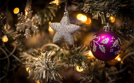 Christmas toys hung on the Christmas tree in the festive evening Stock Photo - Budget Royalty-Free & Subscription, Code: 400-06523327
