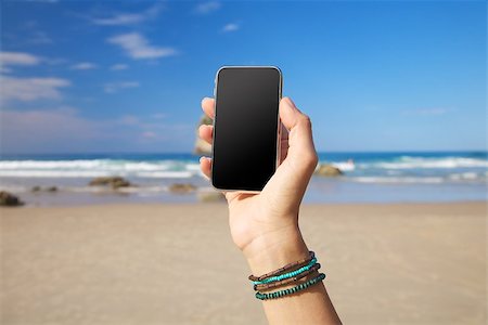 quintanilla (artist) - smart phone in woman hand on a beach in Asturias Spain Photographie de stock - Aubaine LD & Abonnement, Code: 400-06523519