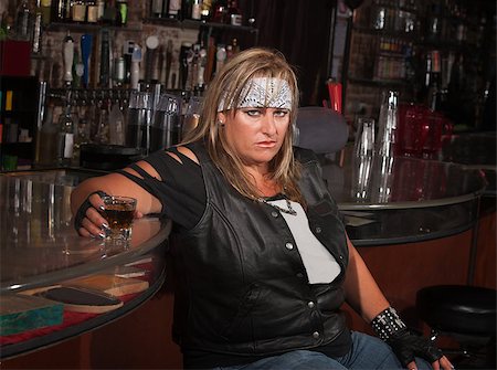 simsearch:400-06396539,k - Angry mature woman with alcohol leaning back in a tavern Stock Photo - Budget Royalty-Free & Subscription, Code: 400-06530597