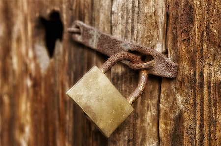 Old window with closed woody shutter and old rust padlock Stock Photo - Budget Royalty-Free & Subscription, Code: 400-06554955