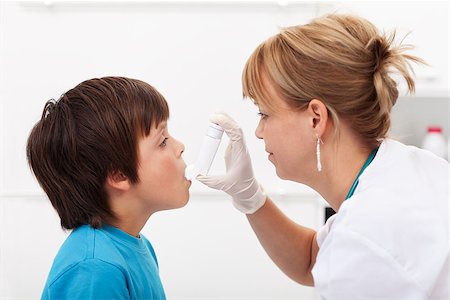 Boy having respiratory illness helped by health professional with inhaler Stock Photo - Budget Royalty-Free & Subscription, Code: 400-06555467