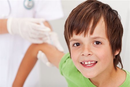 simsearch:400-06553842,k - Happy boy receiving vaccine or injection - health professional in the background Stockbilder - Microstock & Abonnement, Bildnummer: 400-06555469