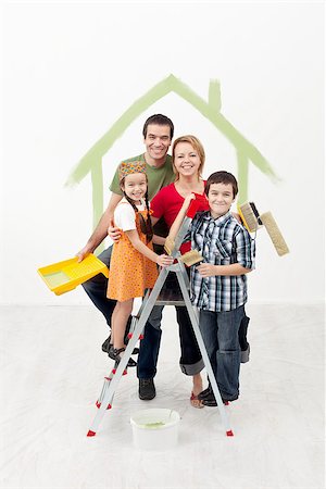 Family with kids painting their new home - smiling and holding utensils Stock Photo - Budget Royalty-Free & Subscription, Code: 400-06555482