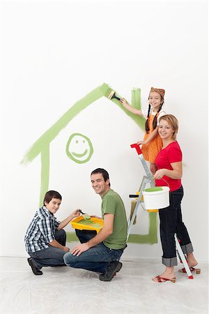 Family with kids redecorating their home - smiling with painting utensils Stock Photo - Budget Royalty-Free & Subscription, Code: 400-06555483