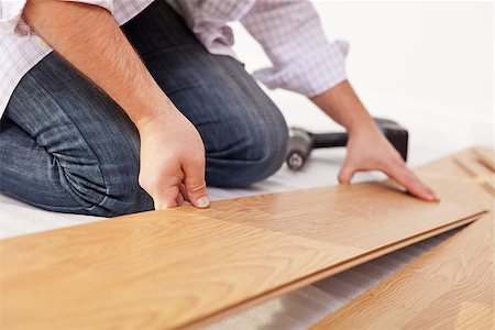 Man laying laminate flooring - closeup on hands Stock Photo - Budget Royalty-Free & Subscription, Code: 400-06555705