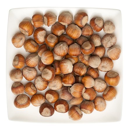 simsearch:400-06520688,k - Plate of hazelnuts isolated on white background Stock Photo - Budget Royalty-Free & Subscription, Code: 400-06555721