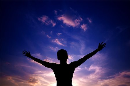 Silhouette or backlit of Asian man open arms raised towards sky on sunset Stock Photo - Budget Royalty-Free & Subscription, Code: 400-06555860