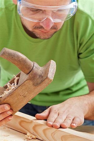 picture of old man construction worker - Man with traditional old planer and slat - manual woodwork, closeup Stock Photo - Budget Royalty-Free & Subscription, Code: 400-06555939