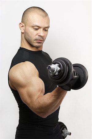 peck - Fit Muscular Brazilian man doing bicep curls with dumbbell Stock Photo - Budget Royalty-Free & Subscription, Code: 400-06556087